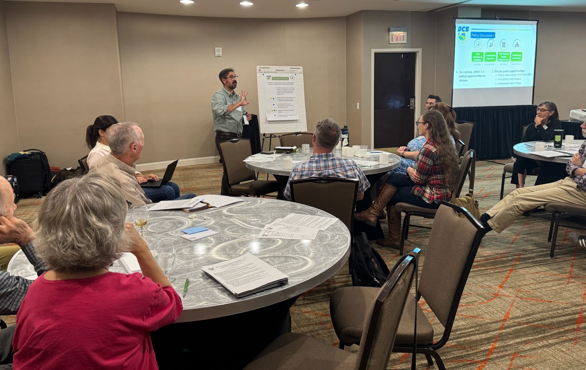 Three jars of soil in a tray with more jars lined up on the right.