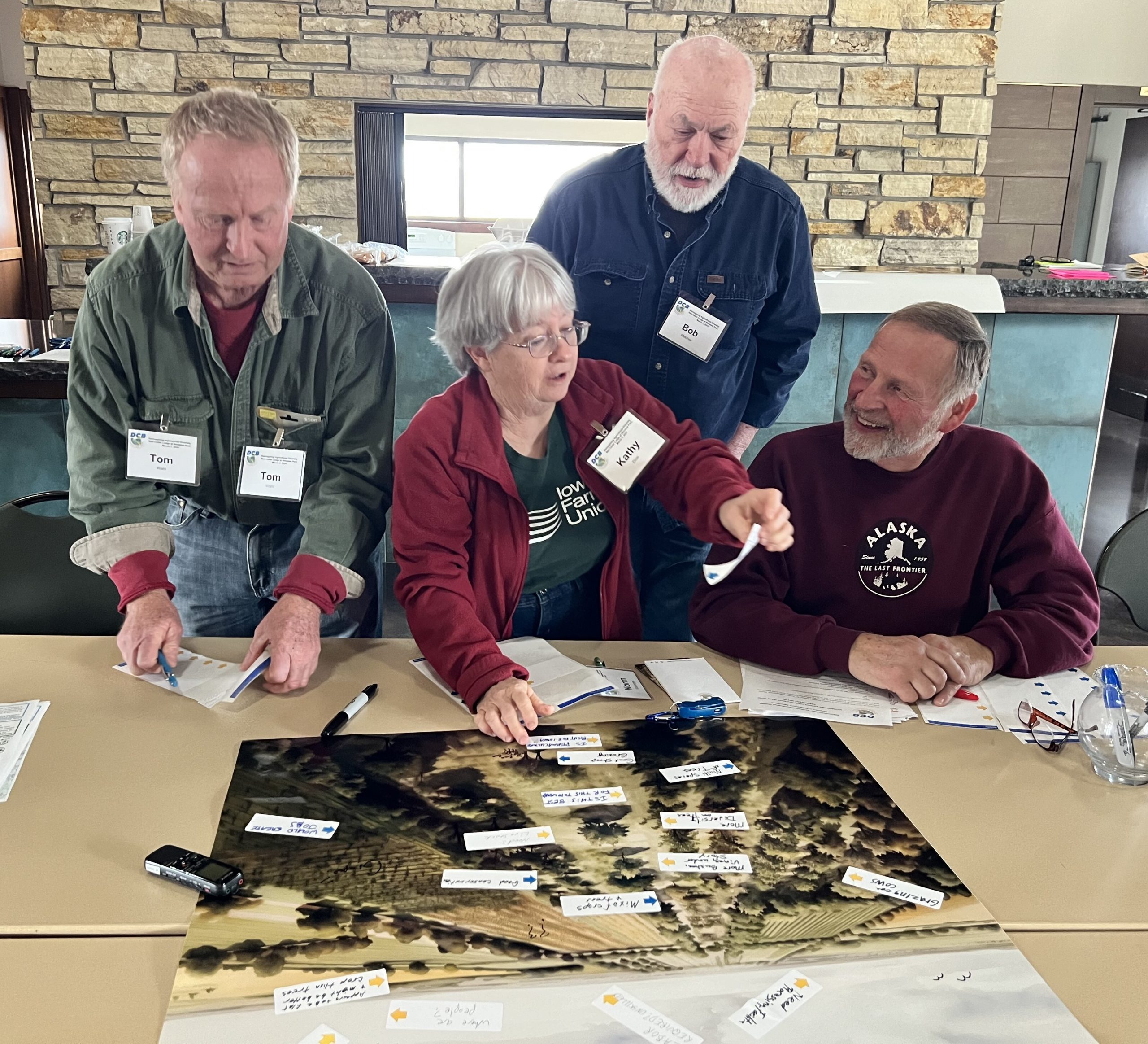 Three jars of soil in a tray with more jars lined up on the right.